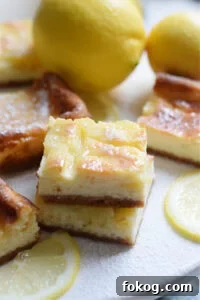 Lemon cheesecake bars on a plate.
