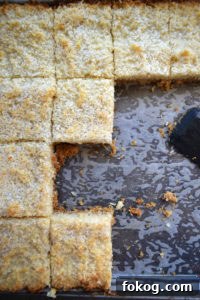 Chewy coconut bars in a baking tray.