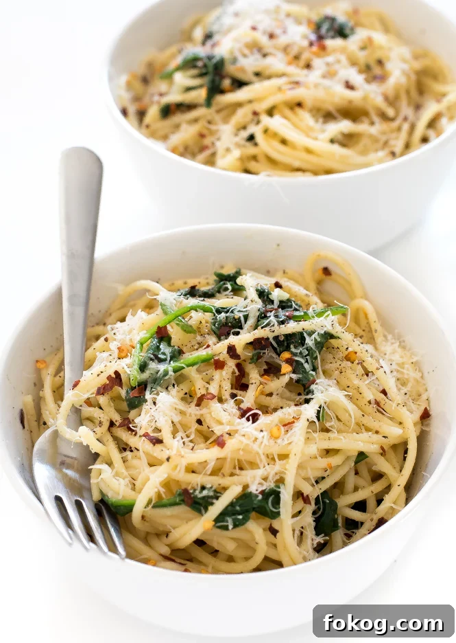 Pasta in a white bowl with a fork.