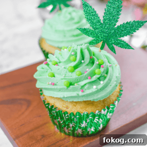 How to Make Cannabis-Infused Cupcakes from Cake Mix 4 A white countertop with a cutting board and a cannabis cupcake topped with green frosting