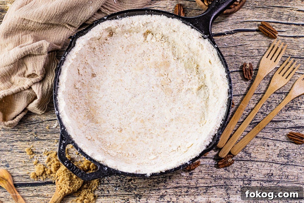 unbaked shortbread crust in a cast iron skillet