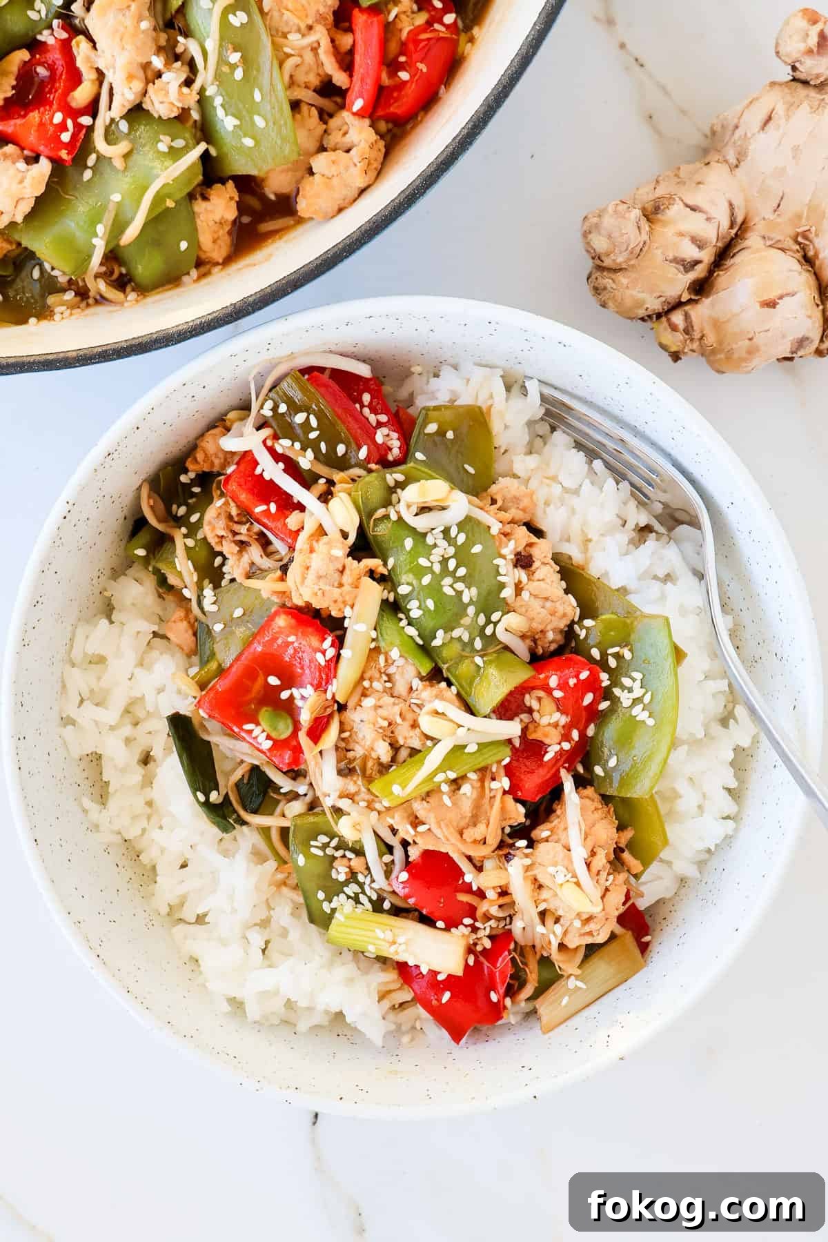 Stir fry in a bowl with rice.