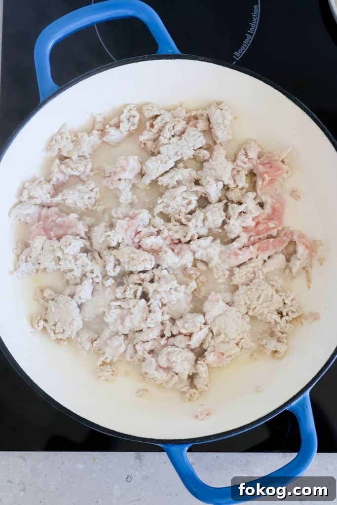 Ground chicken cooked in a skillet.