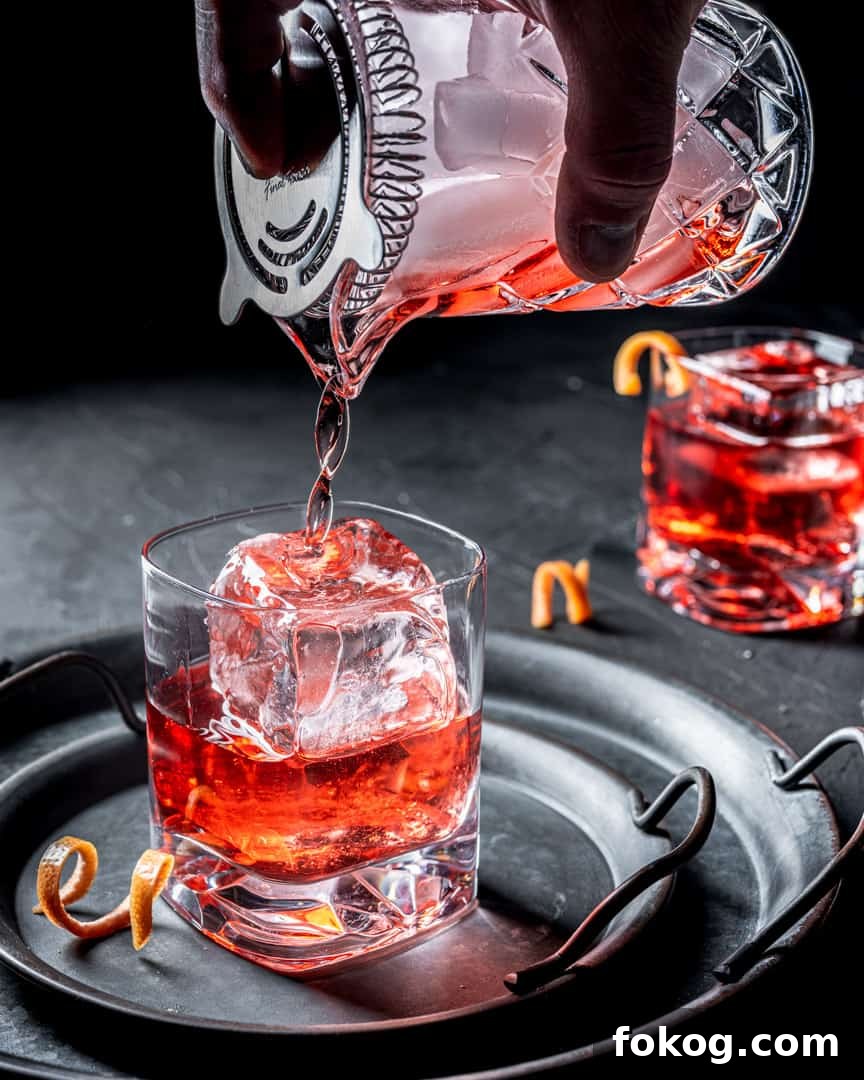 Classic Negroni Recipe: How to Make the Iconic Cocktail 4 Pour the stirred negroni into an ice-filled rocks glass.